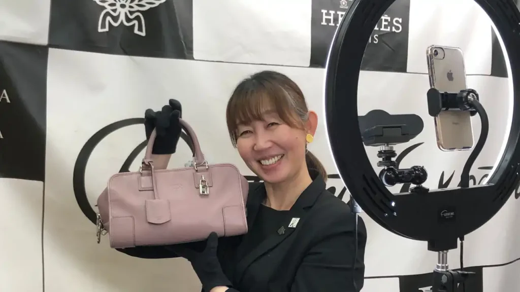 A woman selling luxury bags in a live sale